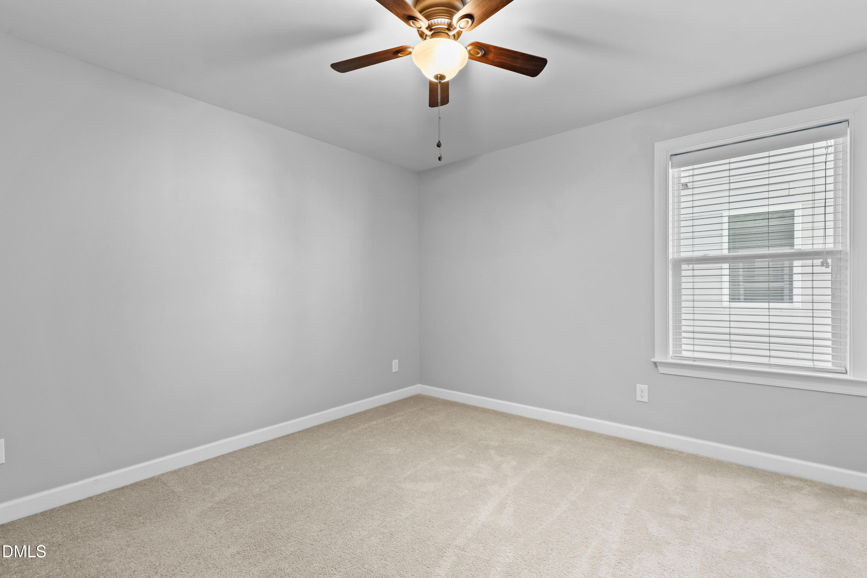 2039 Travern Drive Raleigh, NC 27603 - Photo 40 of 49 an empty room with a window and a fan