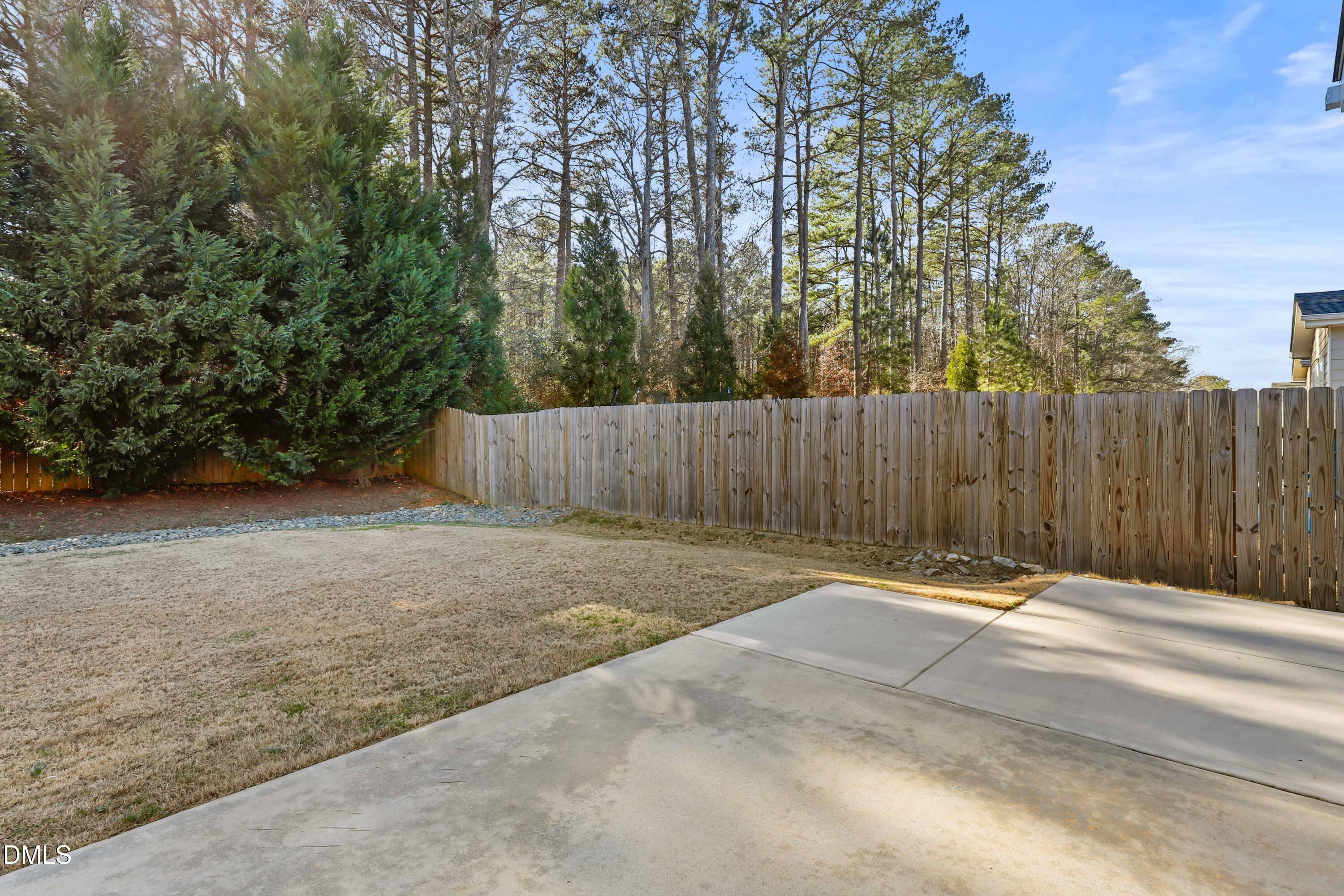 2039 Travern Drive Raleigh, NC 27603 - Photo 45 of 49 a backyard of a house with trees and stairs