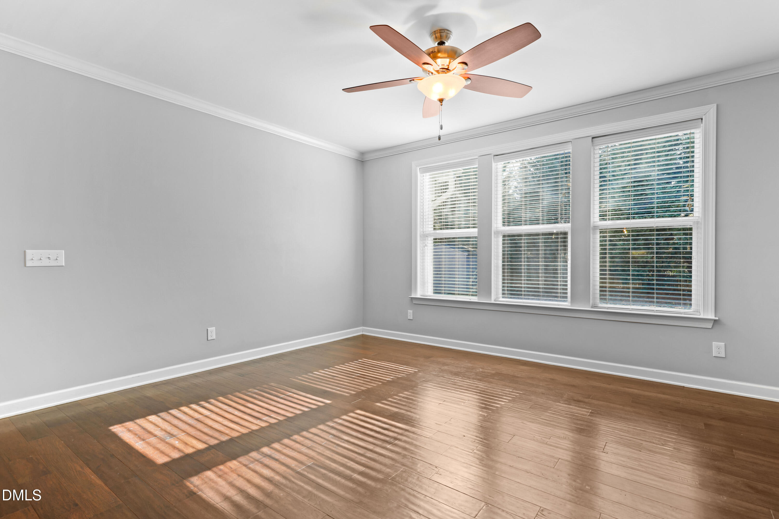 2039 Travern Drive Raleigh, NC 27603 - Photo 5 of 49 a view of an empty room with a window and wooden floor