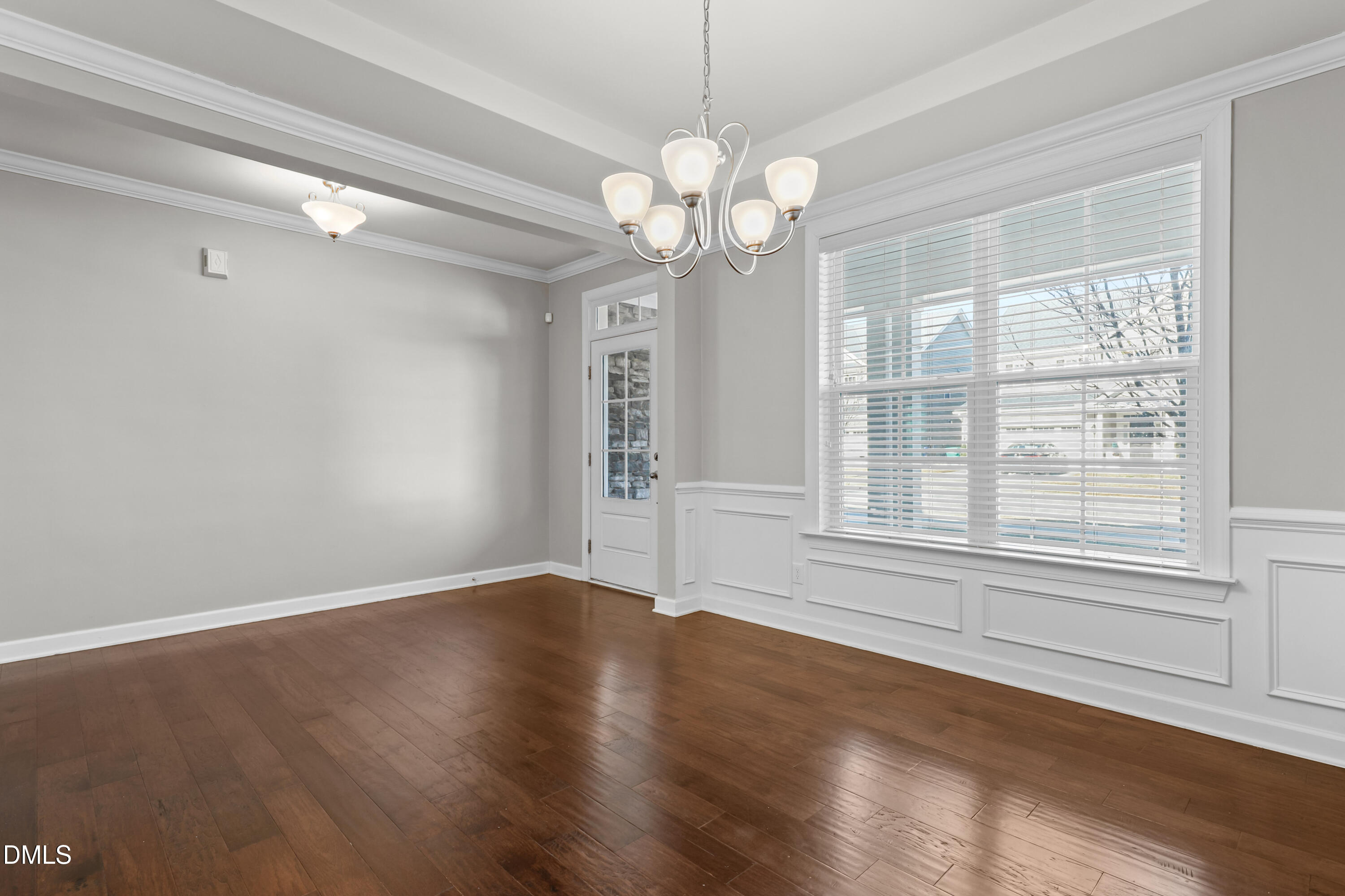 2039 Travern Drive Raleigh, NC 27603 - Photo 6 of 49 a view of an empty room with wooden floor and a window