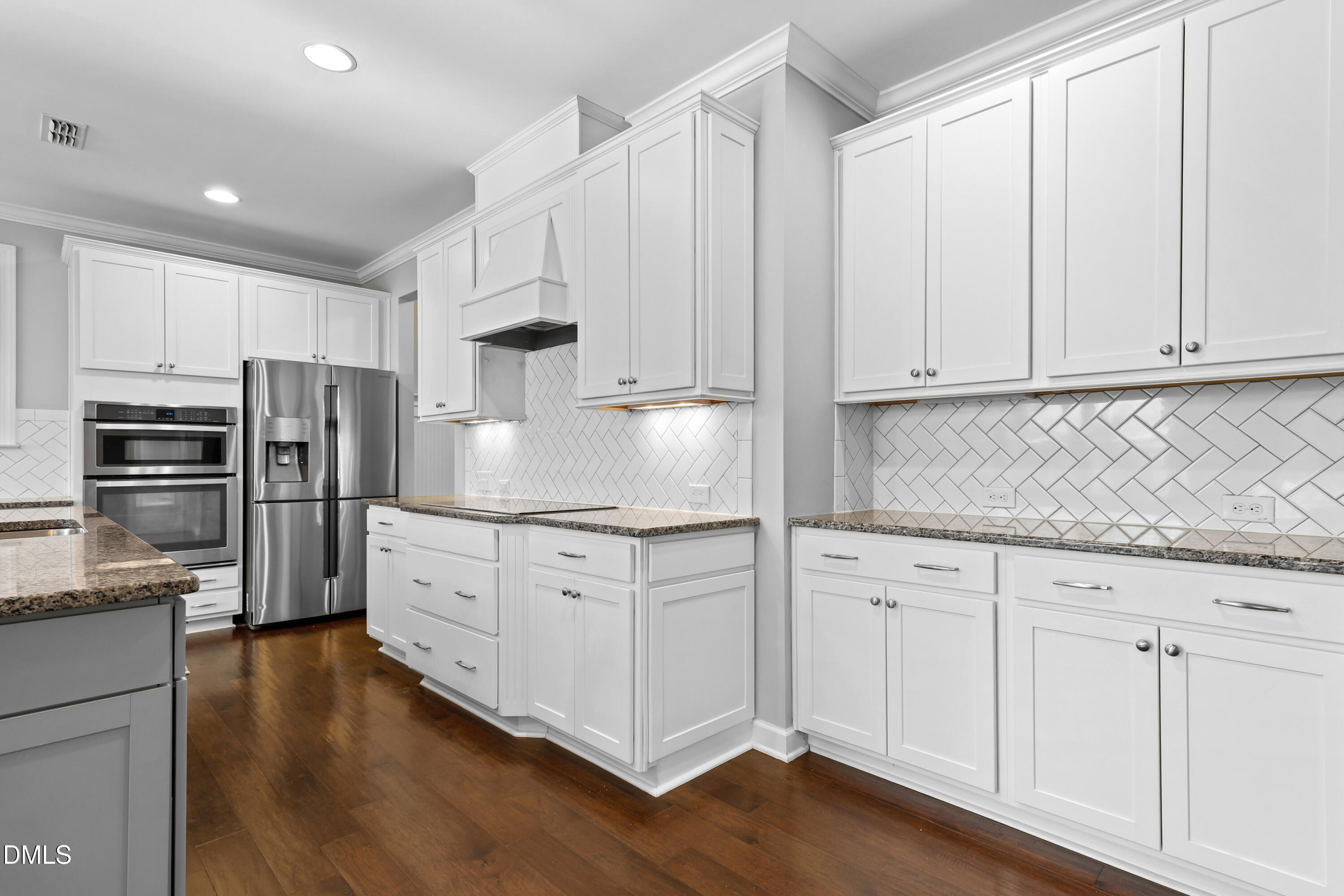 2039 Travern Drive Raleigh, NC 27603 - Photo 8 of 49 a kitchen with granite countertop white cabinets and stainless steel appliances