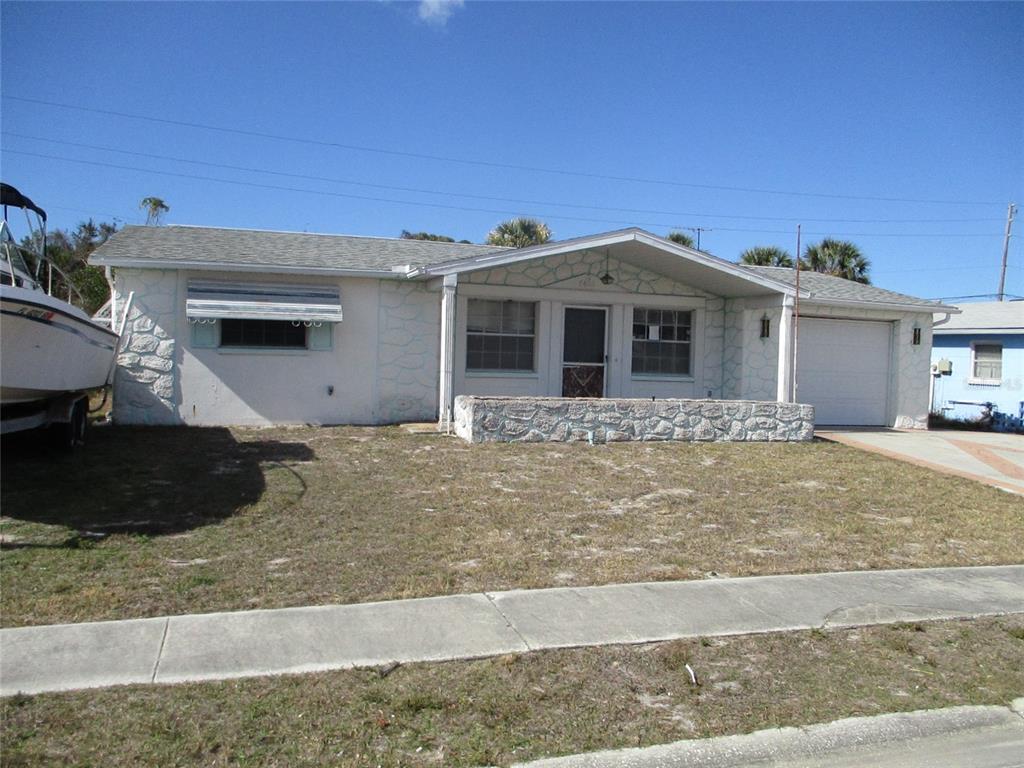 7403 Heather Street New Port Richey, FL 34653 - Photo 1 of 16 a front view of a house with porch