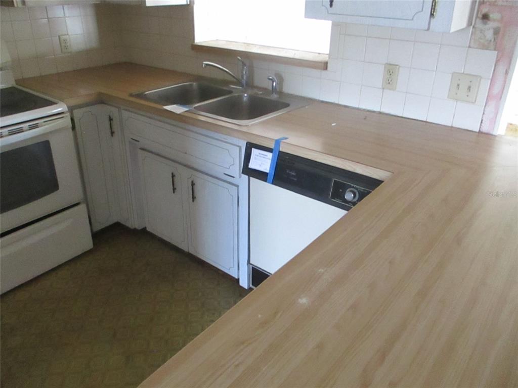 7403 Heather Street New Port Richey, FL 34653 - Photo 11 of 16 a kitchen that has a sink and a stove