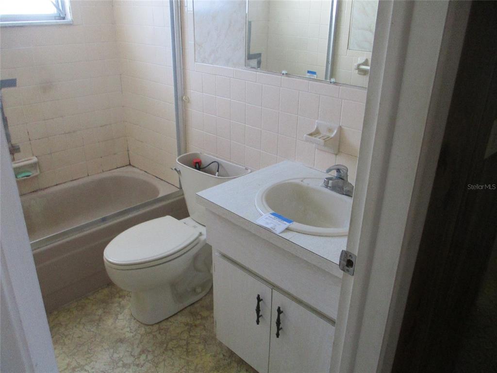7403 Heather Street New Port Richey, FL 34653 - Photo 16 of 16 a bathroom with a sink a toilet and shower