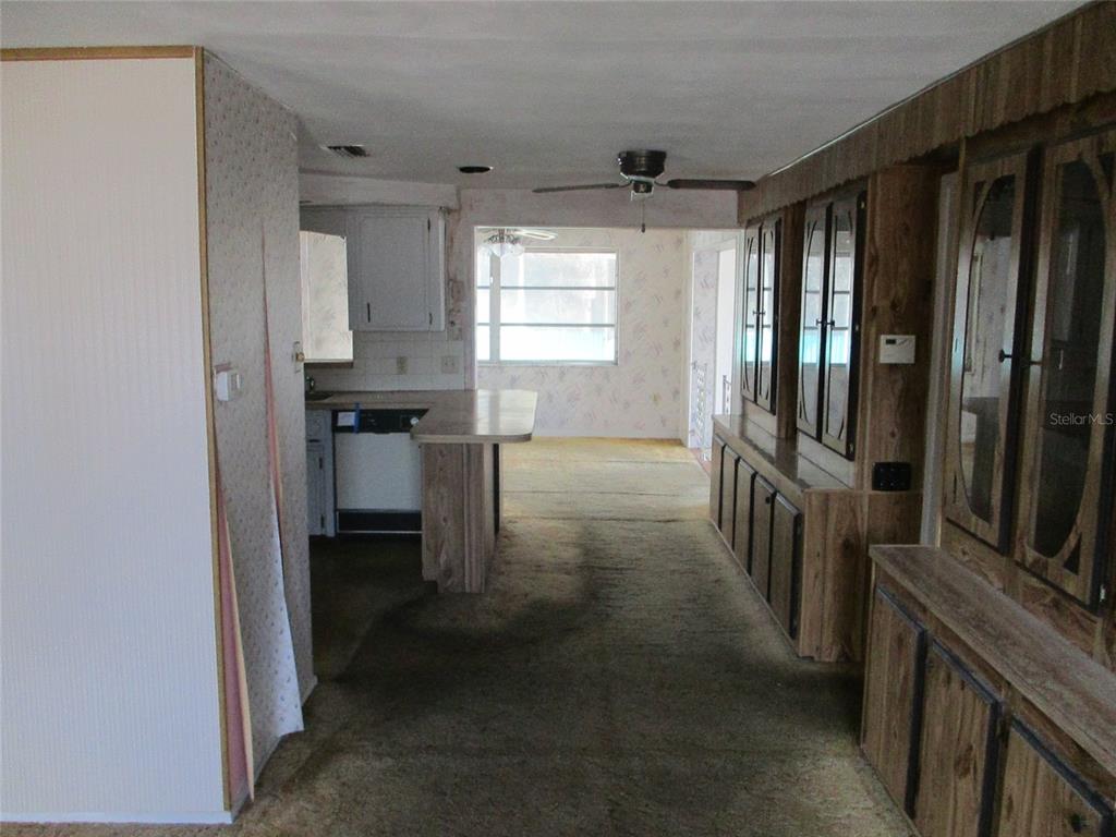 7403 Heather Street New Port Richey, FL 34653 - Photo 6 of 16 a kitchen with sink cabinets and window