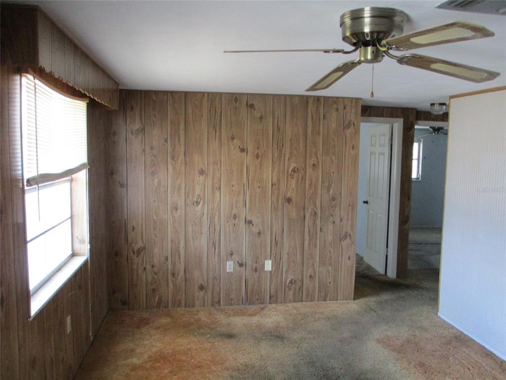 7403 Heather Street New Port Richey, FL 34653 - Photo 7 of 16 a view of a hallway with a window