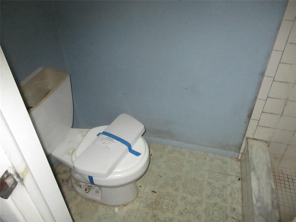 7403 Heather Street New Port Richey, FL 34653 - Photo 9 of 16 a bathroom with a toilet and a sink