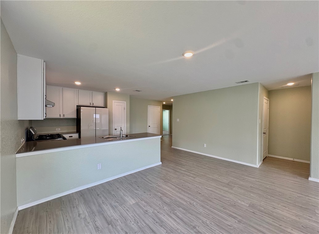1109 Demeter Drive Portland, TX 78374 - Photo 4 of 18 a large kitchen with a wooden floor and a large window