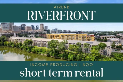 a view of a lake with houses in the back