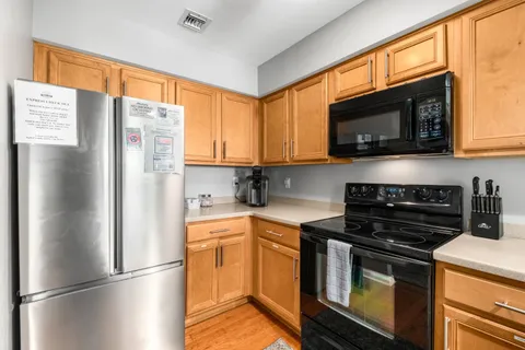 a kitchen with a sink a stove and cabinets