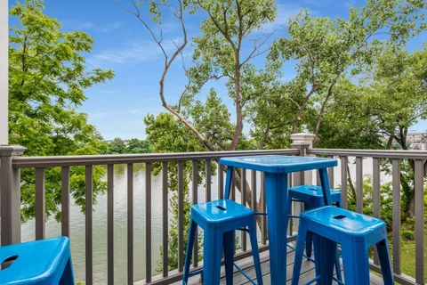 a view of a patio with couches table and chairs and potted plants