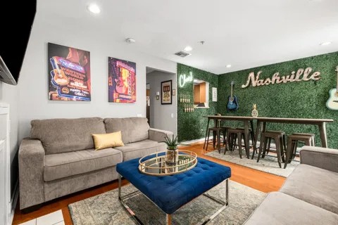 a living room with furniture a flat screen tv and a fireplace