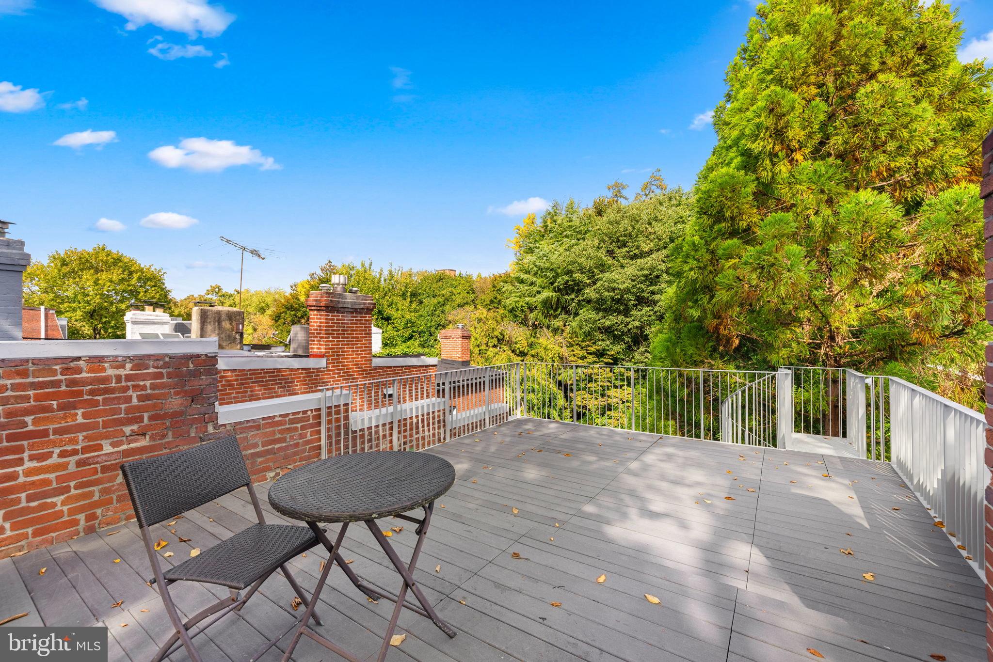 2813 Q Street Northwest Washington, DC 20007 - Photo 15 of 22 a backyard of a house with table and chairs
