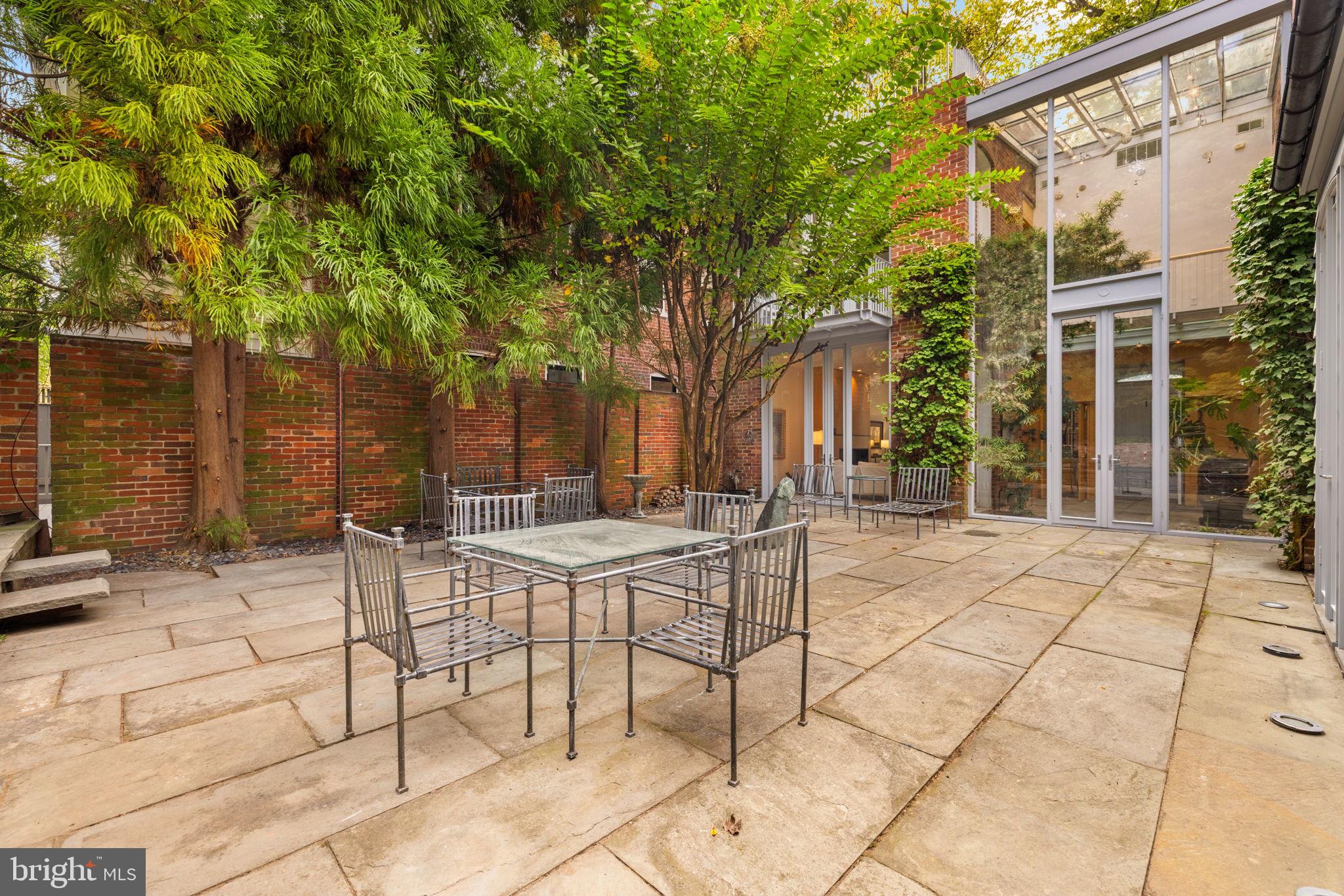2813 Q Street Northwest Washington, DC 20007 - Photo 20 of 22 a view of a patio with a table and chairs and potted plants