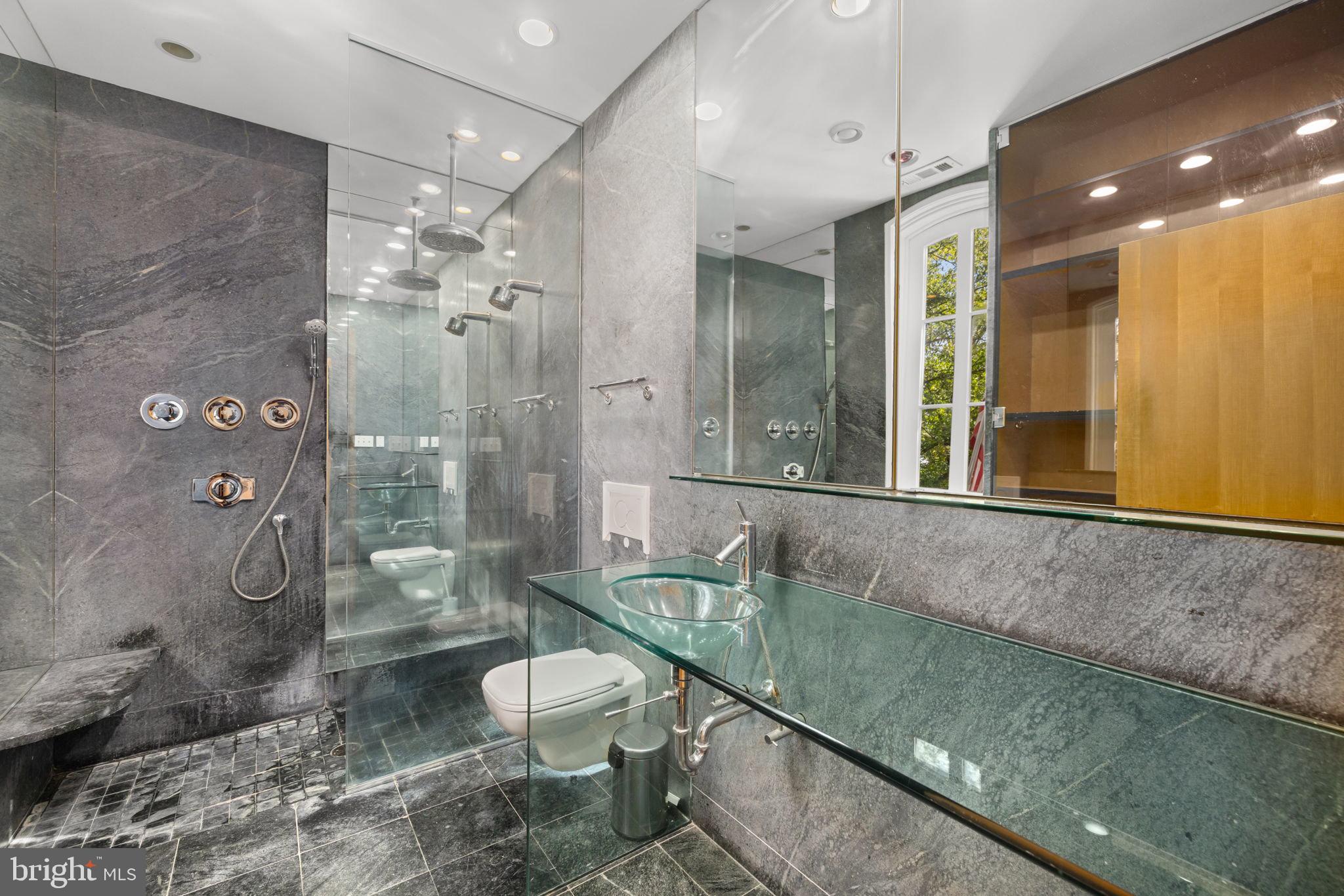 2813 Q Street Northwest Washington, DC 20007 - Photo 9 of 22 a bathroom with a granite countertop sink a toilet a mirror and shower