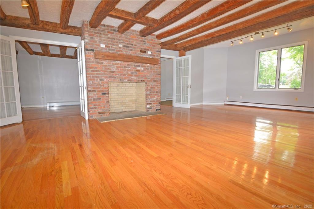 405 Maple Avenue Cheshire, CT 06410 - Photo 12 of 37 a view of empty room with wooden floor and fan