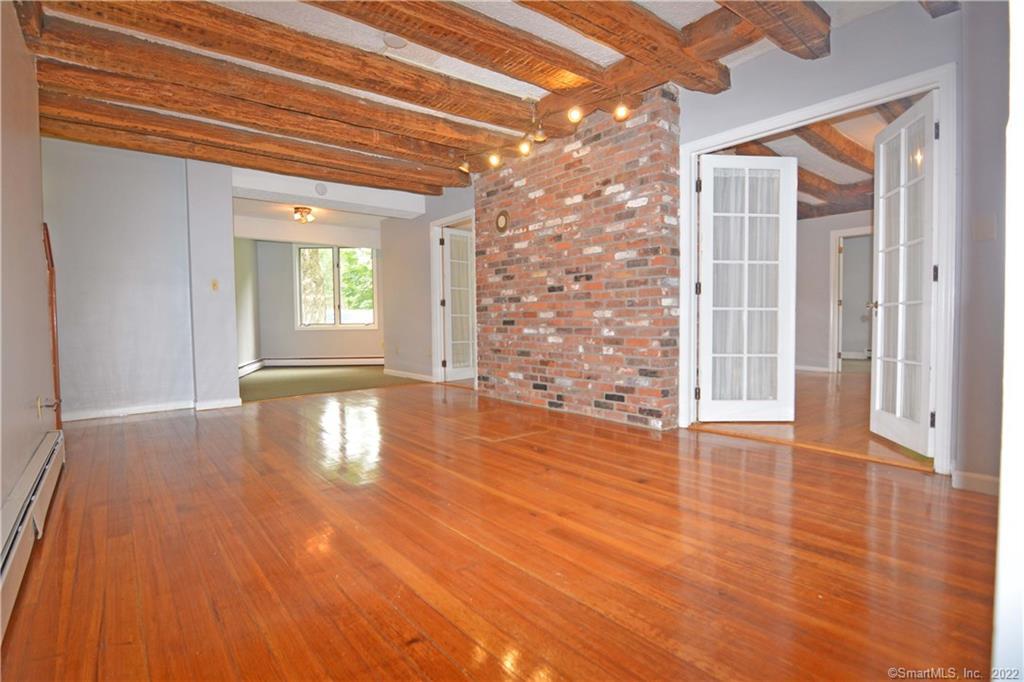 405 Maple Avenue Cheshire, CT 06410 - Photo 13 of 37 a view of an empty room with wooden floor and a window