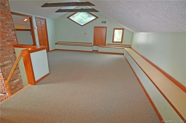 view of room with window and stairs