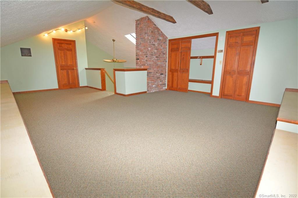 405 Maple Avenue Cheshire, CT 06410 - Photo 22 of 37 a view of a room with closet and mirror