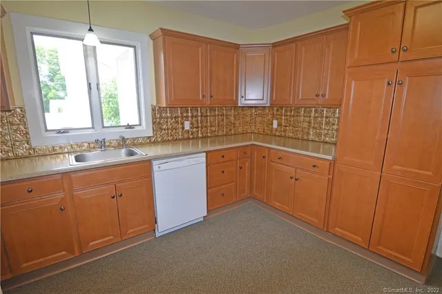a kitchen with sink cabinets and window