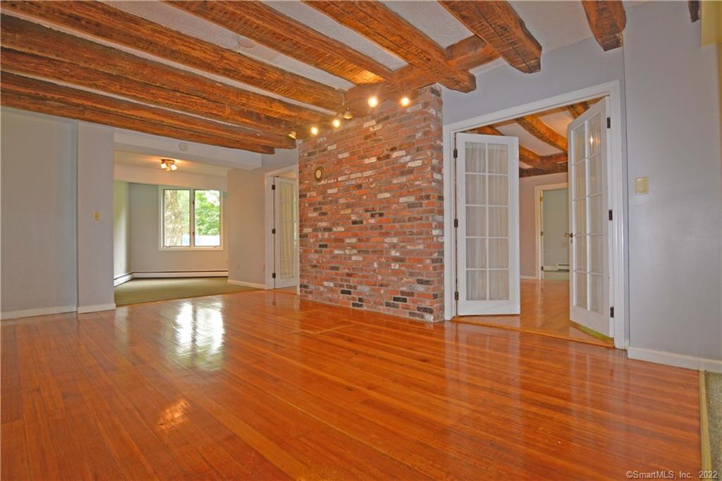 405 Maple Avenue Cheshire, CT 06410 - Photo 9 of 37 a view of empty room with wooden floor and fan