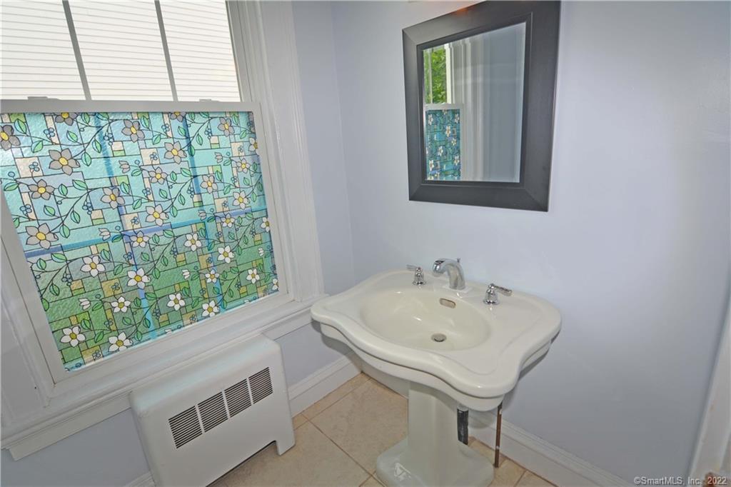 405 Maple Avenue Cheshire, CT 06410 - Photo 10 of 37 a bathroom with a sink and a window