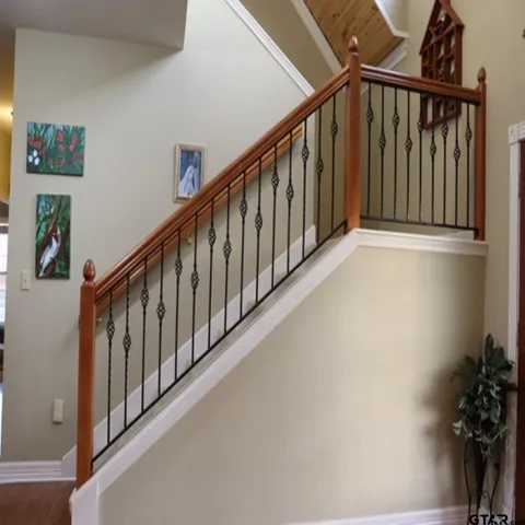 a view of staircase with lots of frames on wall