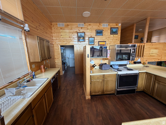 358 South Sky Drive Torrey, UT 84775 - Photo 20 of 82 Kitchen featuring wood-paneled walls and ceiling, wood-finish flooring, and light-toned countertops