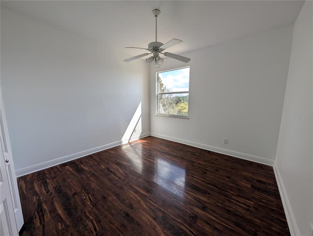 7436 Islander Lane Hudson, FL 34667 - Photo 11 of 27 a view of a livingroom with wooden floor and a ceiling fan