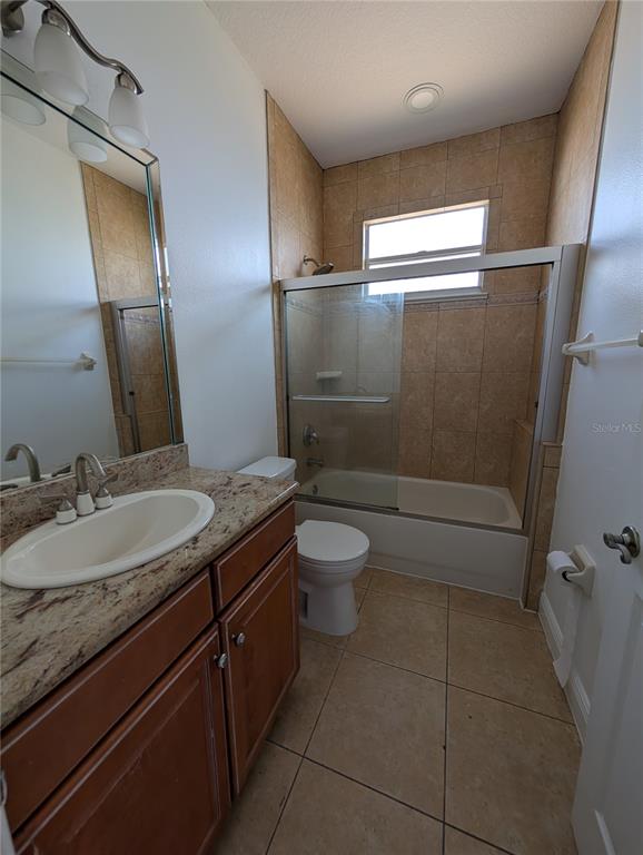7436 Islander Lane Hudson, FL 34667 - Photo 13 of 27 a bathroom with a granite countertop sink a toilet and a mirror