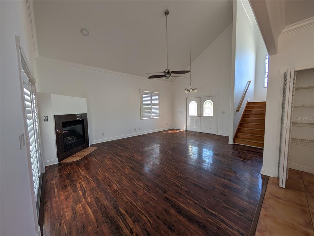 7436 Islander Lane Hudson, FL 34667 - Photo 14 of 27 a view of a livingroom with wooden floor fireplace and stairs