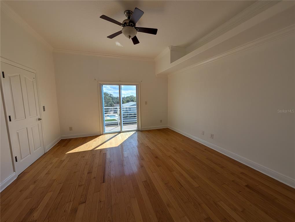 7436 Islander Lane Hudson, FL 34667 - Photo 16 of 27 an empty room with wooden floor and windows