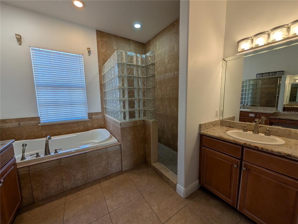 7436 Islander Lane Hudson, FL 34667 - Photo 20 of 27 a bathroom with a tub sink and mirror