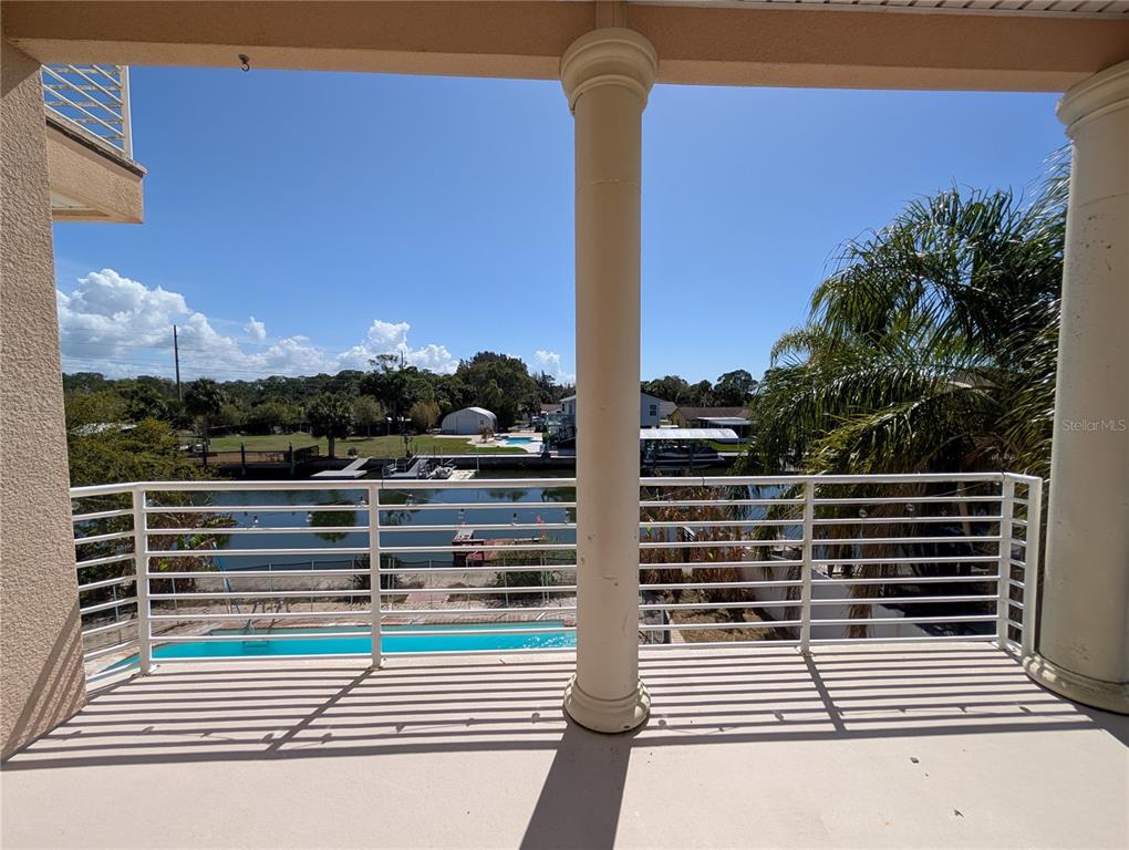 7436 Islander Lane Hudson, FL 34667 - Photo 2 of 27 a view of a balcony with a floor to ceiling window and an outdoor view