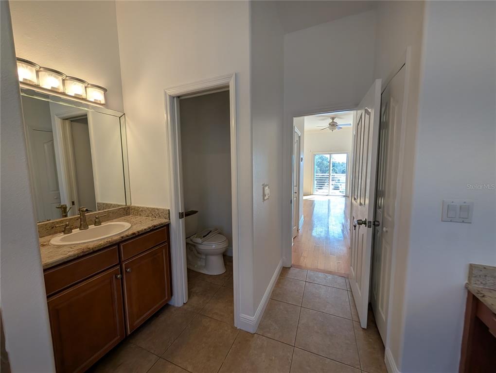 7436 Islander Lane Hudson, FL 34667 - Photo 21 of 27 a bathroom with a granite countertop sink a toilet and a mirror