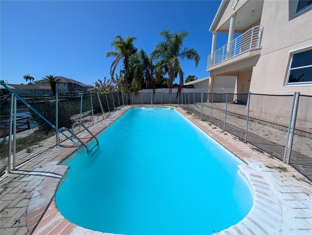 7436 Islander Lane Hudson, FL 34667 - Photo 24 of 27 a view of a swimming pool with lounge chair