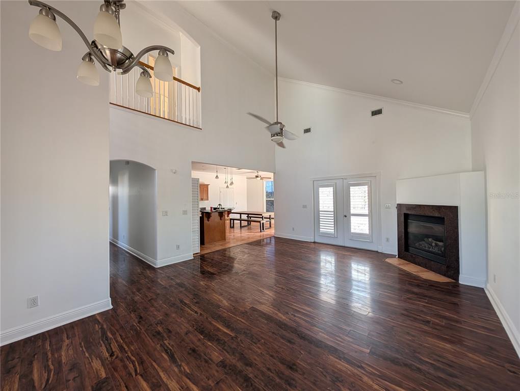 7436 Islander Lane Hudson, FL 34667 - Photo 5 of 27 a view of empty room with wooden floor and fireplace