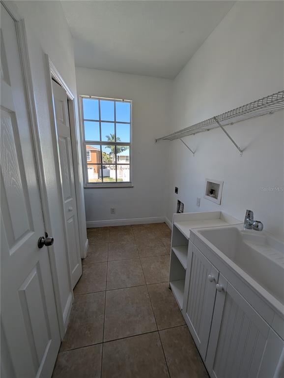 7436 Islander Lane Hudson, FL 34667 - Photo 9 of 27 a view of a bathroom with a sink and dishwasher next to a window