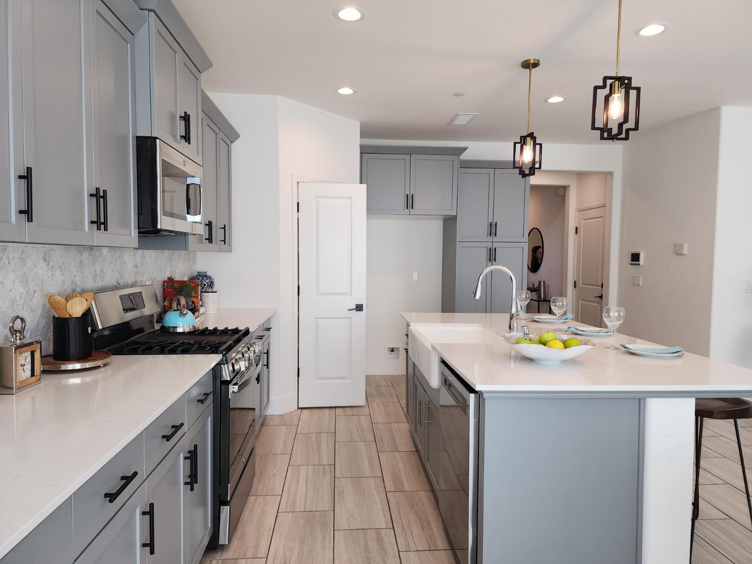 4254 Oak Knoll Road Madera, CA 93636 - Photo 12 of 74 a kitchen with stainless steel appliances a sink stove and refrigerator