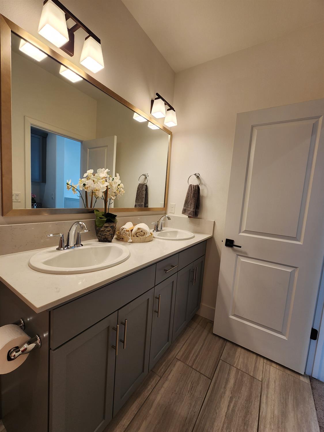 4254 Oak Knoll Road Madera, CA 93636 - Photo 23 of 74 a bathroom with a double vanity sink and mirror