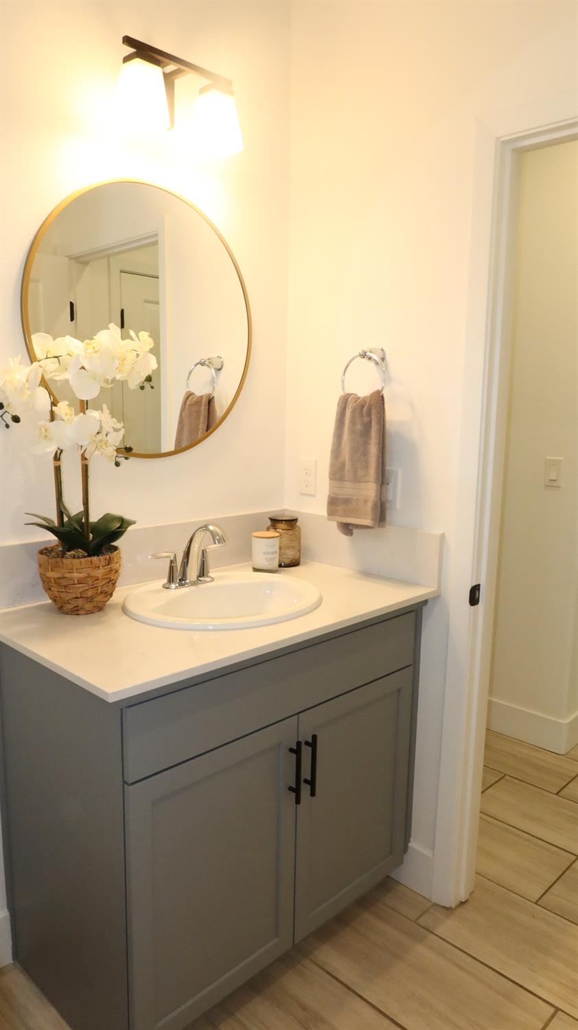 4254 Oak Knoll Road Madera, CA 93636 - Photo 6 of 74 a bathroom with a sink and a mirror