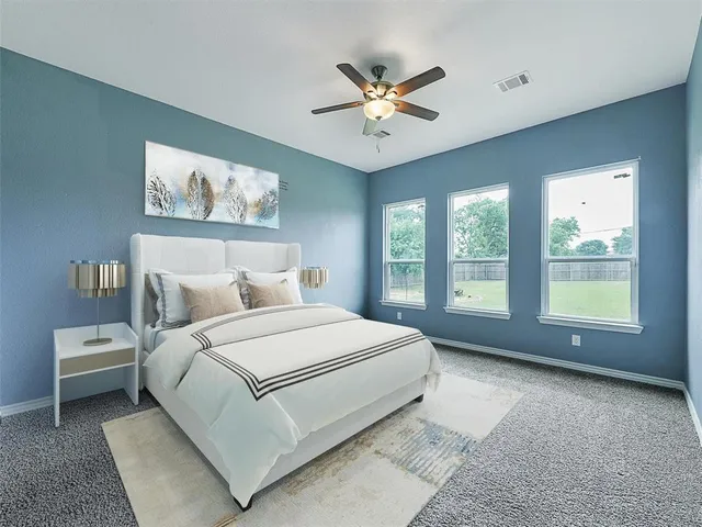 a bedroom with a large bed and a window
