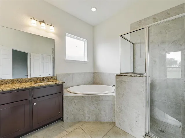 a bathroom with a granite countertop sink a mirror and a toilet