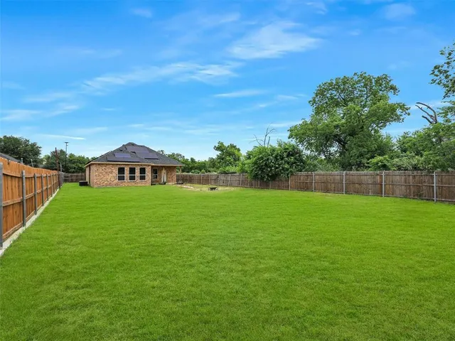 a view of a garden with a building in the background