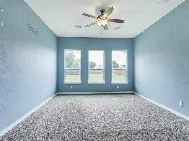 a view of room with a ceiling fan and window