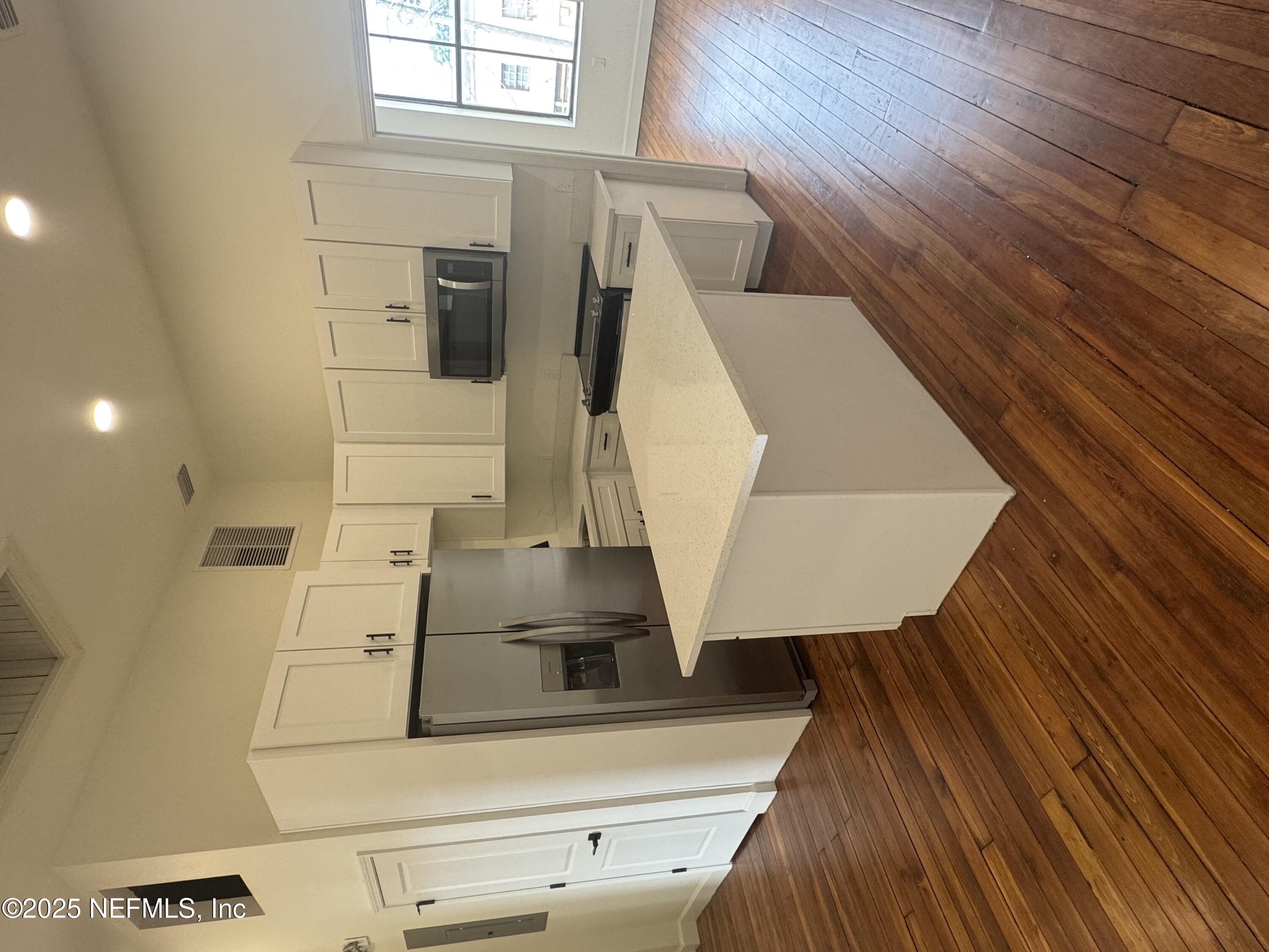 a kitchen with stainless steel appliances a white stove top oven and refrigerator