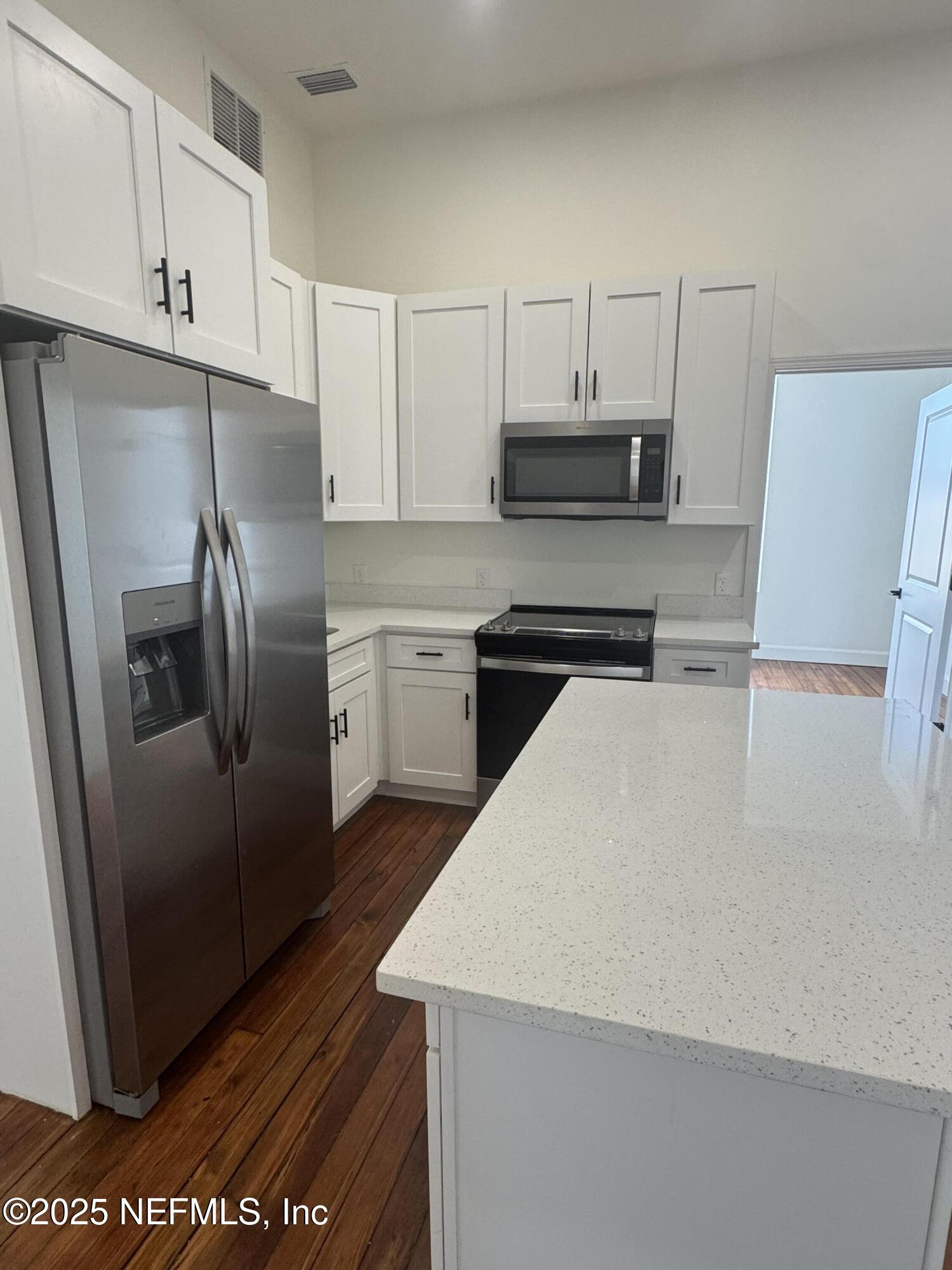 115 East Call Street Starke, FL 32091 - Photo 5 of 11 a kitchen with stainless steel appliances a refrigerator sink and microwave