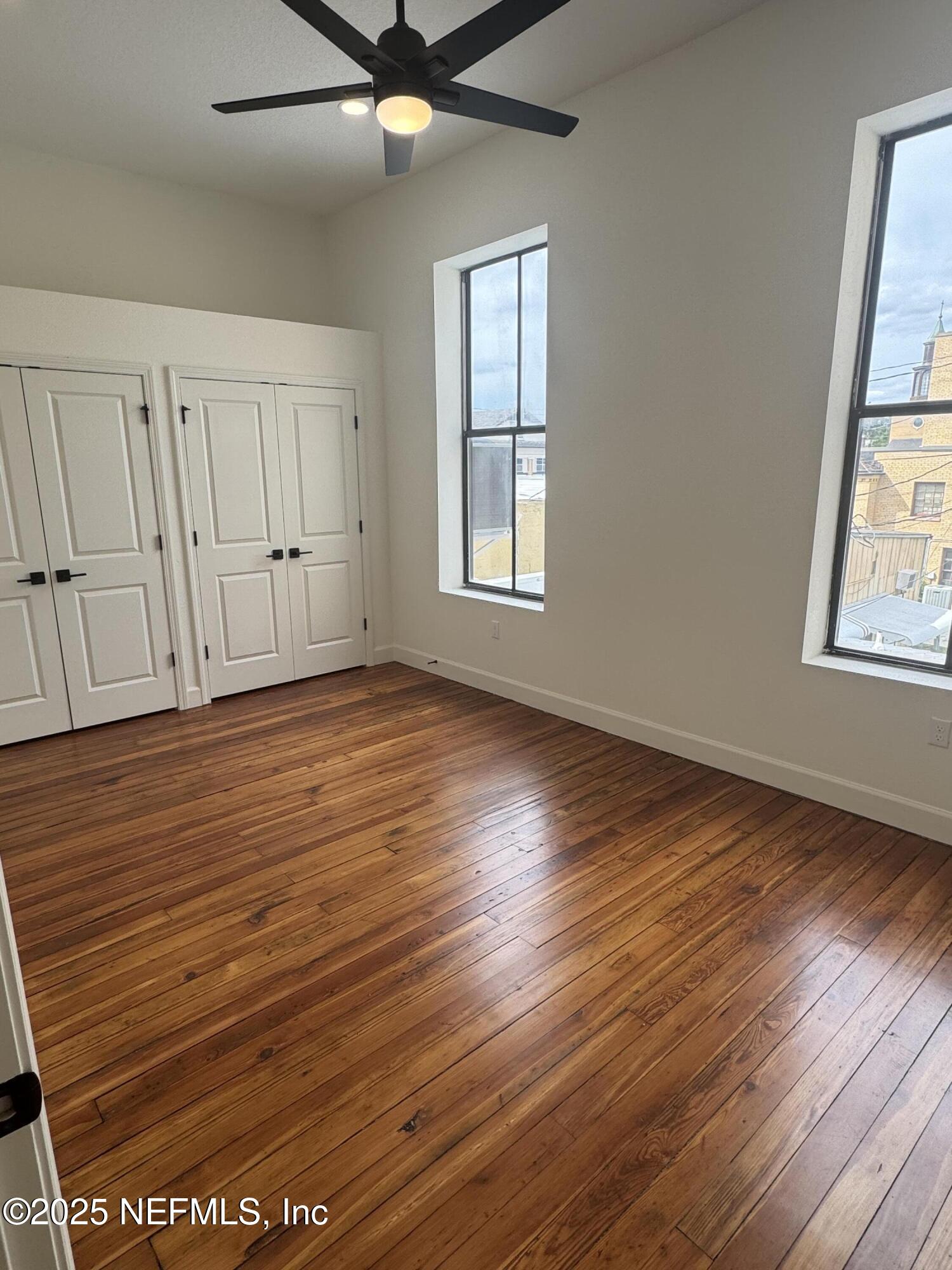 115 East Call Street Starke, FL 32091 - Photo 6 of 11 an empty room with wooden floor and windows