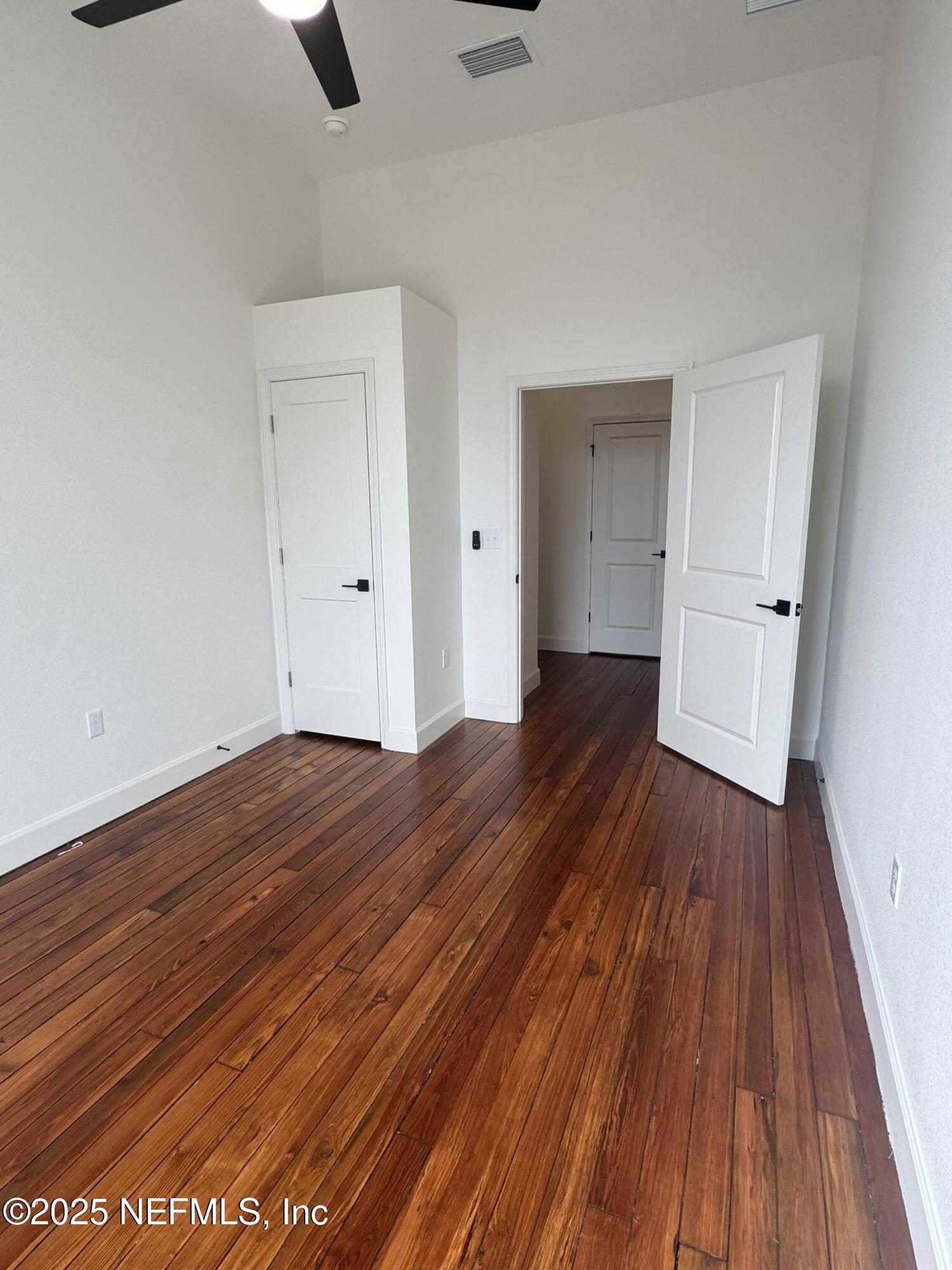115 East Call Street Starke, FL 32091 - Photo 9 of 11 a view of a room with wooden floor and white walls
