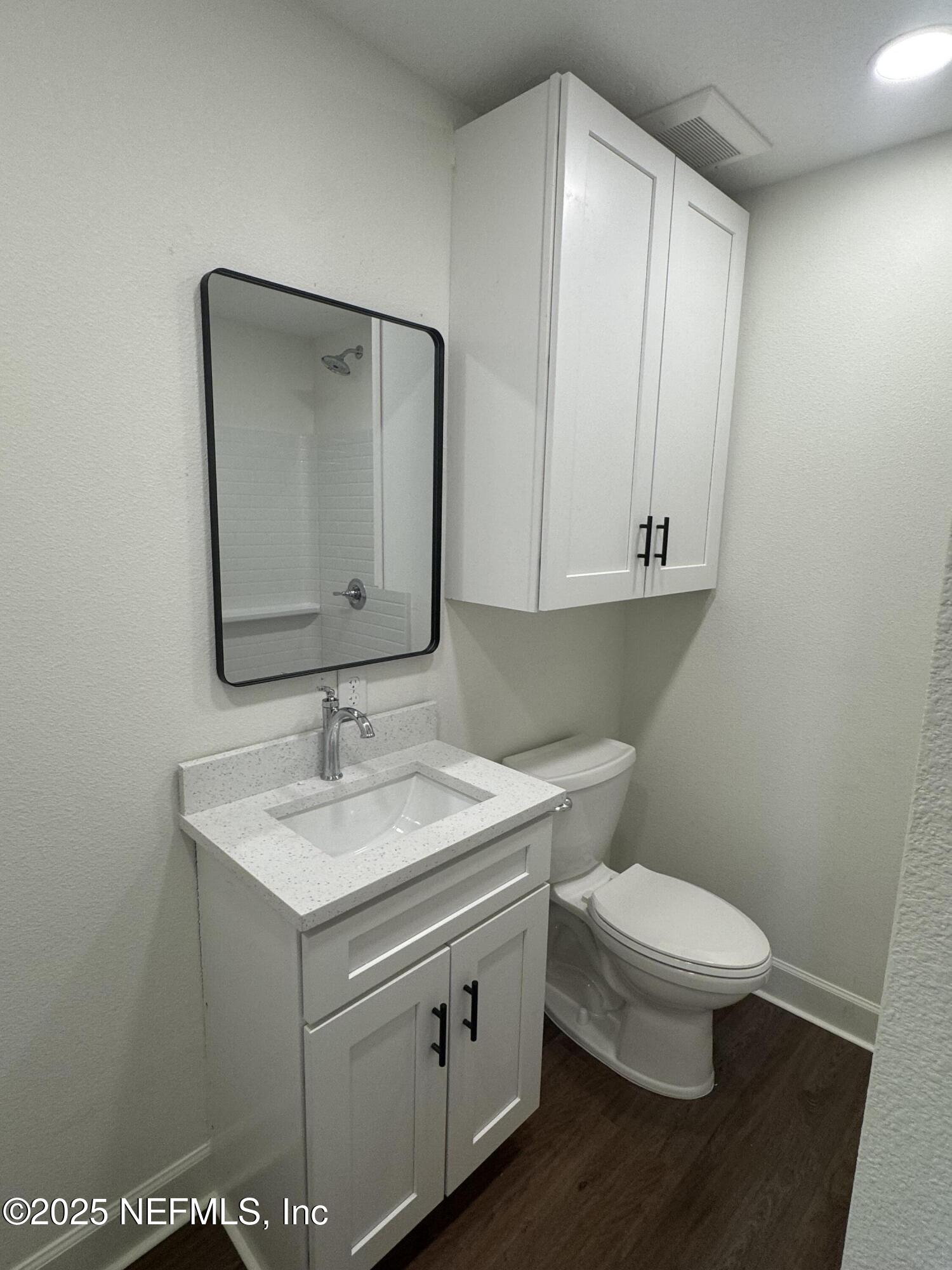 115 East Call Street Starke, FL 32091 - Photo 10 of 11 a bathroom with a toilet sink and mirror